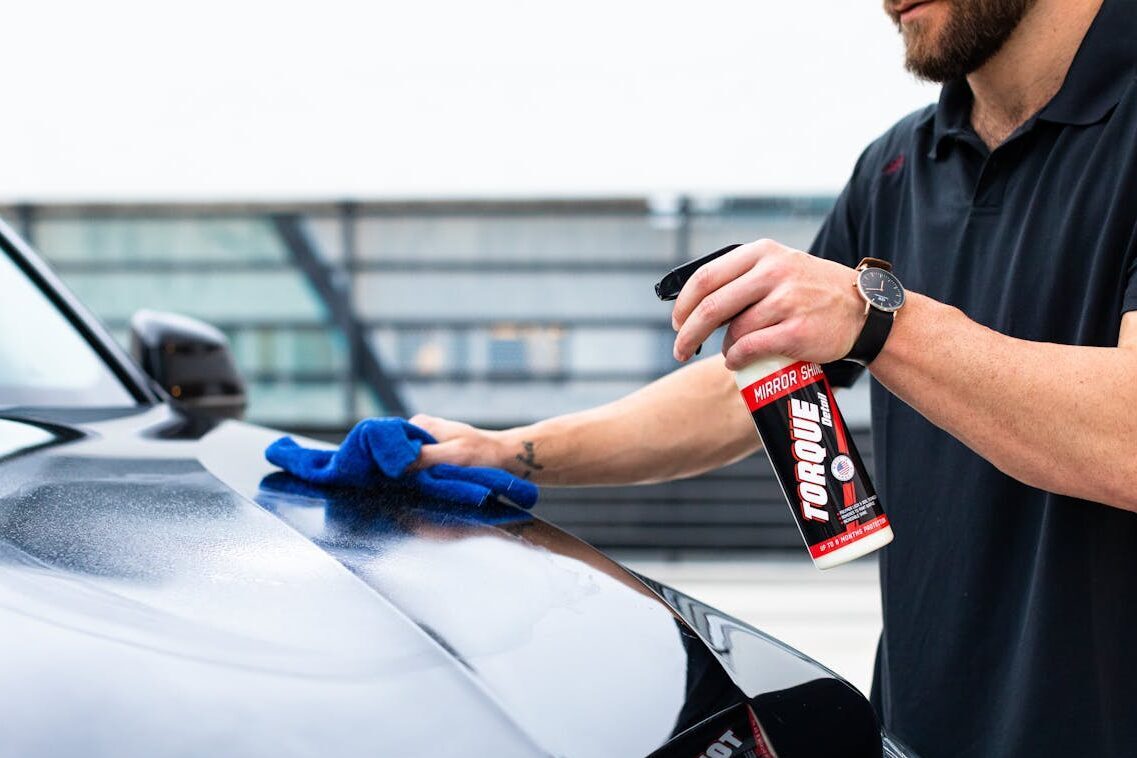 Man Cleaning the Hood of a Car 